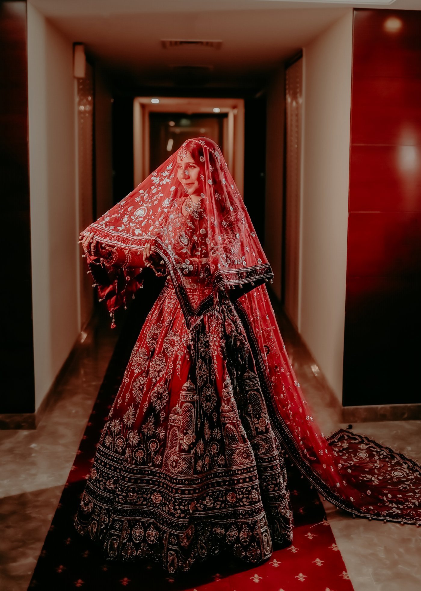 A bride and groom sharing a kiss beneath her veil